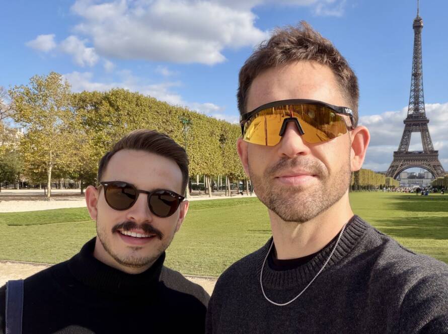 Andrew Curry and Dylan Cunningham selfie at Eiffel Tower in Paris wearing sunglasses on sunny day at Champ de Mars
